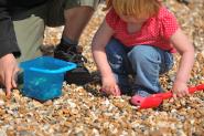 Child with bucket and spade on the beach