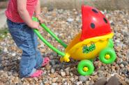 Child on beach with toy buggy