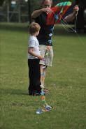 Man and boy in a park with a kite